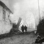 Infantrymen advance under fire, Pont-Le-Ban, Belgium, January 1945