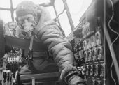 Flying Officer checks settings on control panel on an Avro Lancaster B Mark III